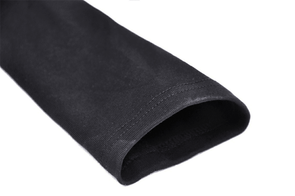 Close-up of the sleeve of a stylish black asymmetrical off-the-shoulder punk top with dark gothic vibes.