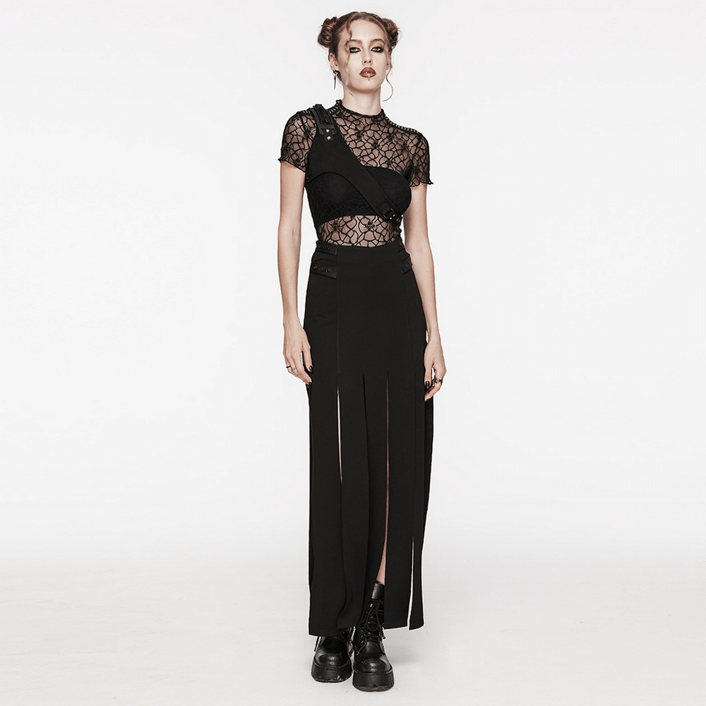 Stylish female wearing black micro twill O-ring chest harness with adjustable straps, paired with a lace top and long skirt.