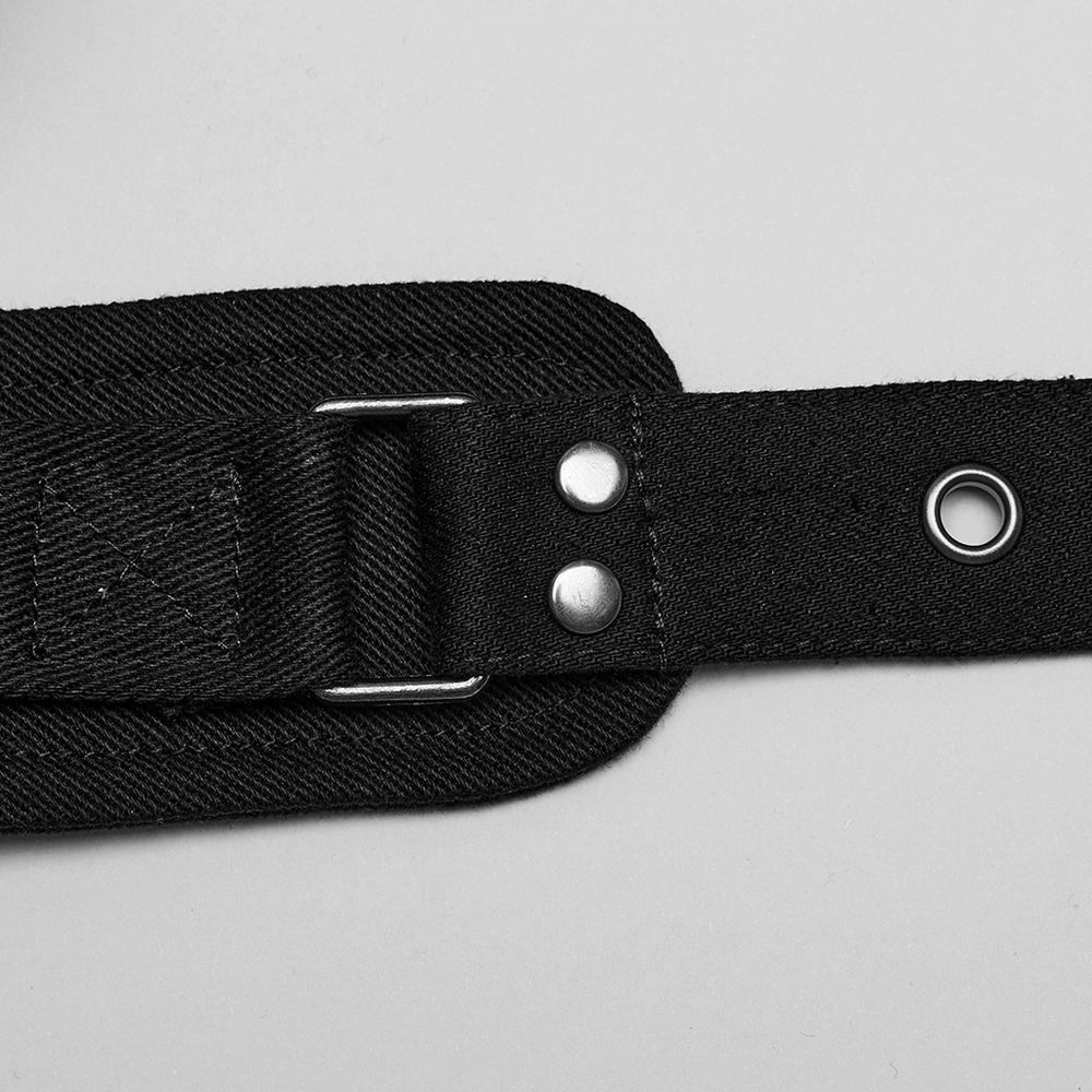 Black micro twill O-ring harness strap detail with metallic accents and adjustable buckle for a punk-inspired edgy look.