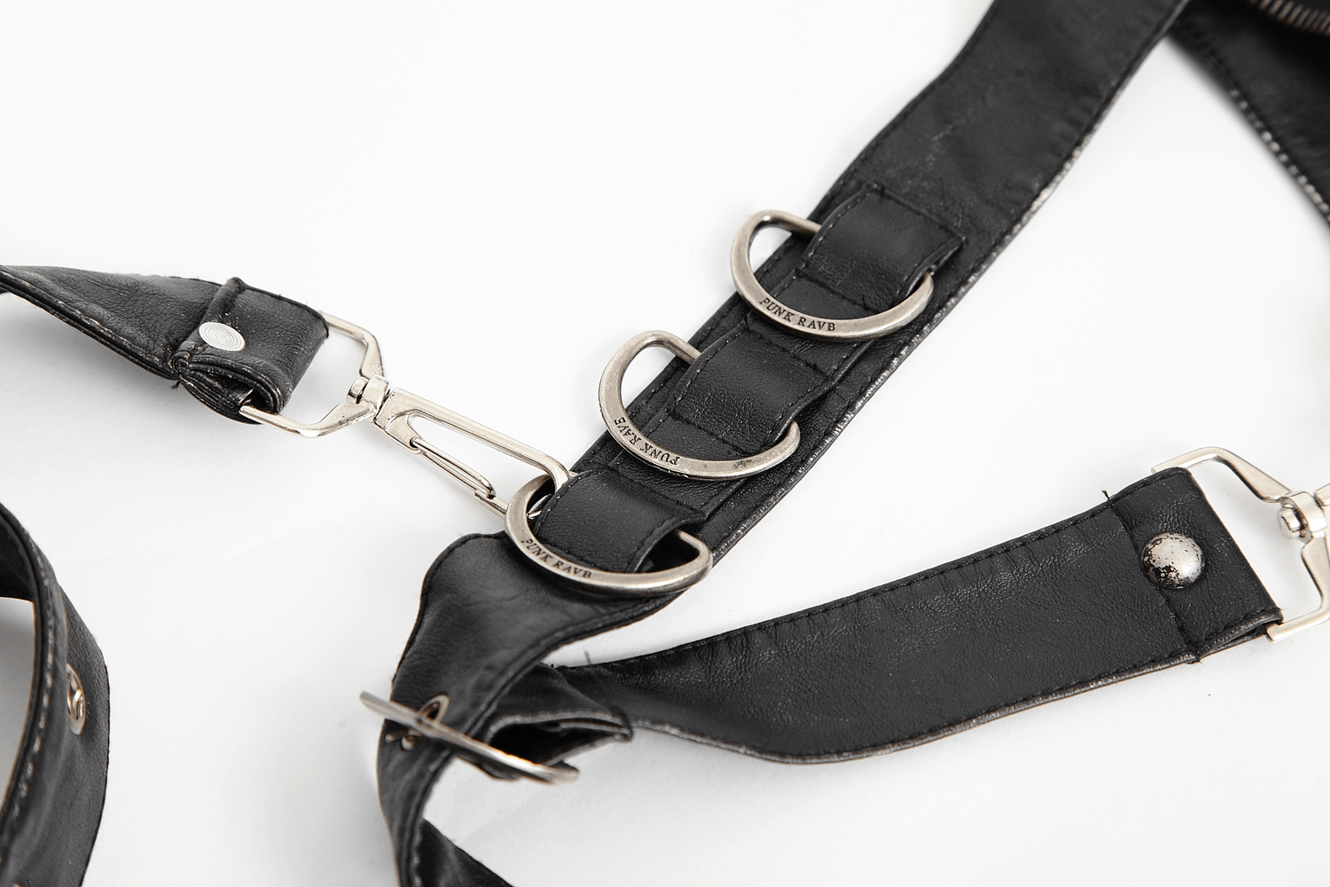 Close-up of antique silver hardware and adjustable straps on a stylish black leather waist bag.
