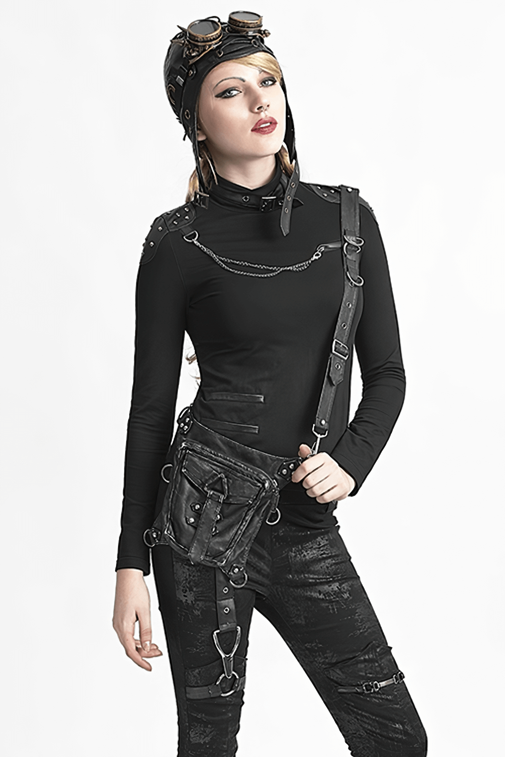 Stylish model in black outfit with gothic leather waist bag and accessories, embodying punk rebellion.