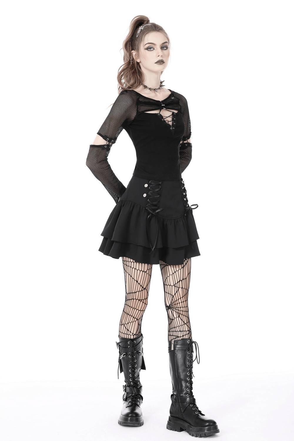 Stylish female in a black mesh goth top with lace-up sleeves and a flared skirt, showcasing a striking edgy look.