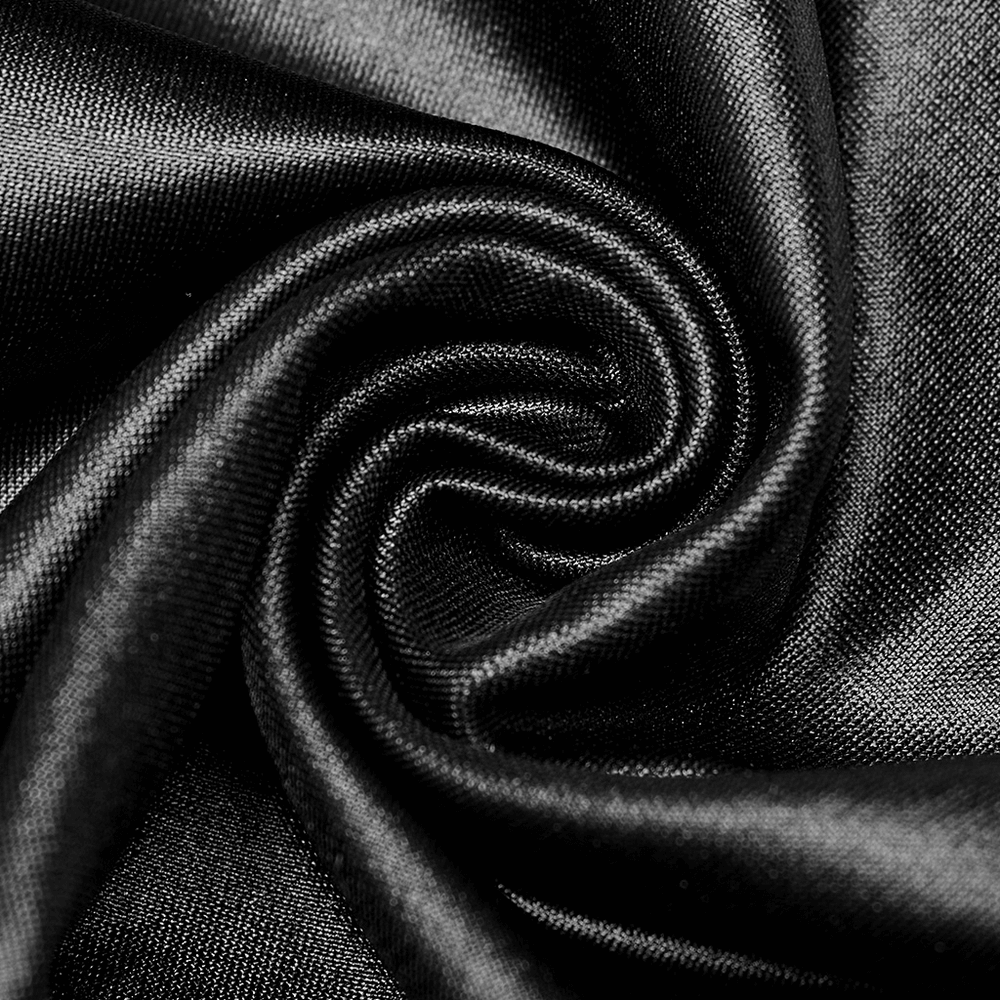 Close-up of glossy black faux leather fabric with intricate folds, highlighting the luxurious texture and sheen.