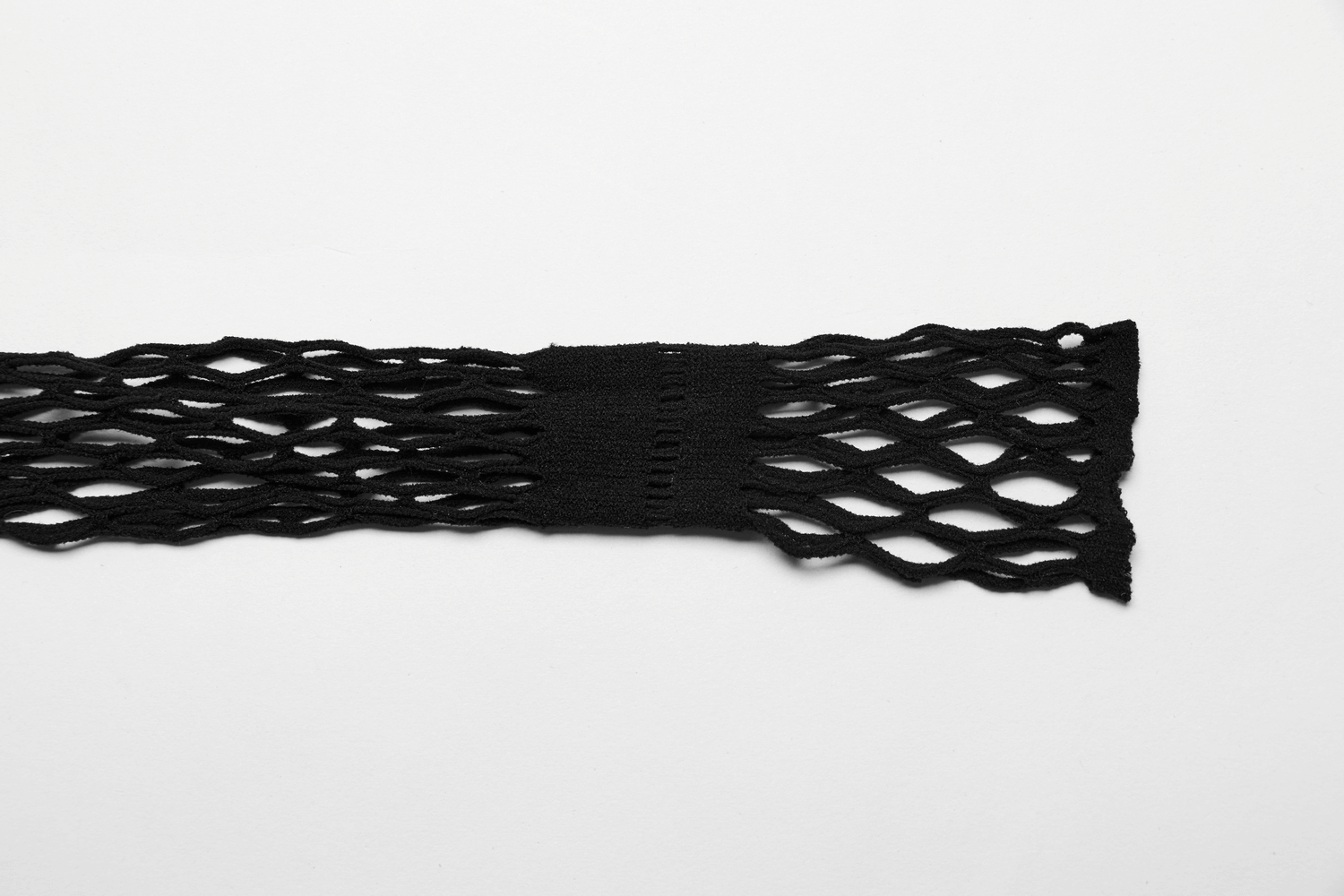 Close-up of stylish black fishnet fabric, perfect for edgy lingerie sets and layering in fashion ensembles.