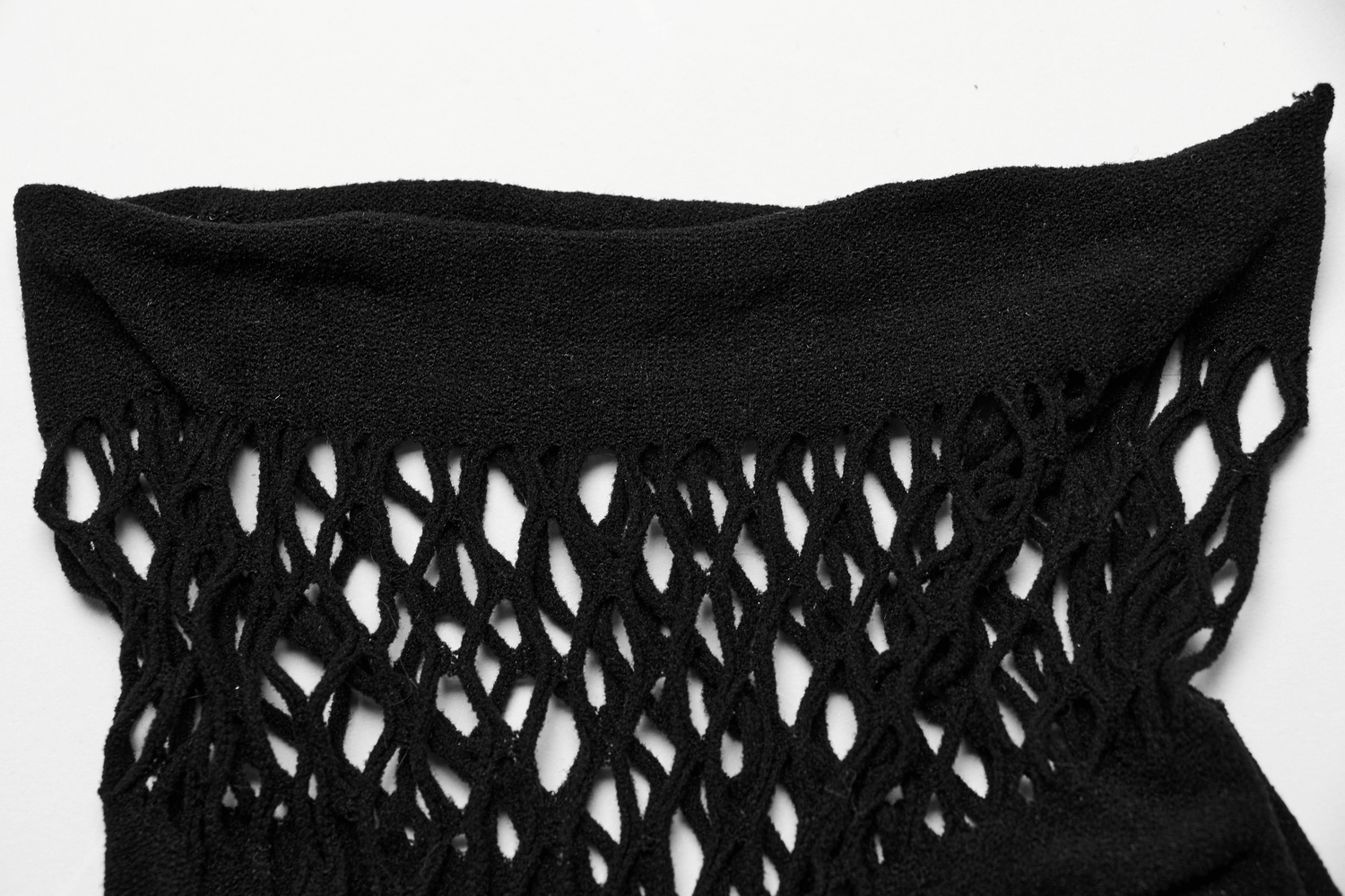Close-up of stylish black fishnet fabric with off-shoulder design, perfect for edgy lingerie ensembles.