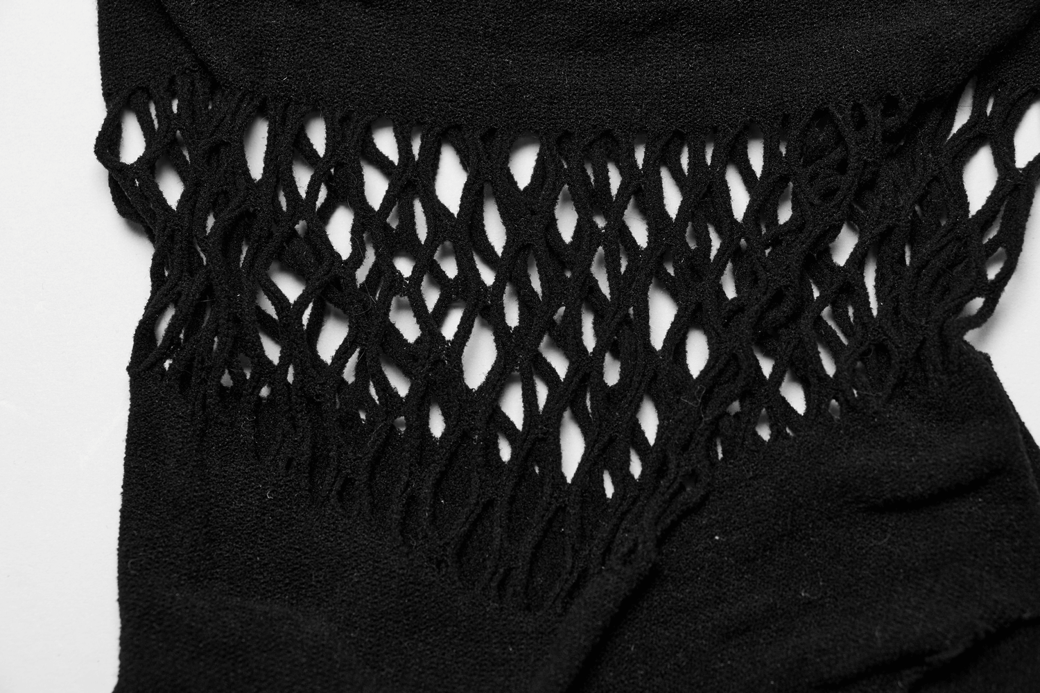 Close-up of stylish black fishnet detailing on an off-shoulder top, perfect for edgy lingerie looks.