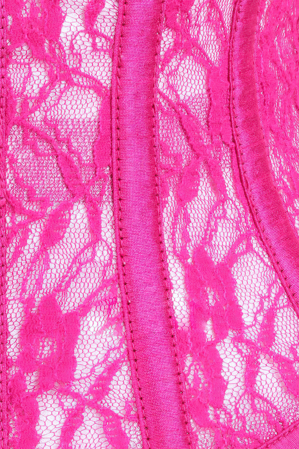 Close-up of a stylish fuchsia lace mesh corset, showcasing intricate lace details and vibrant color for waist shaping.