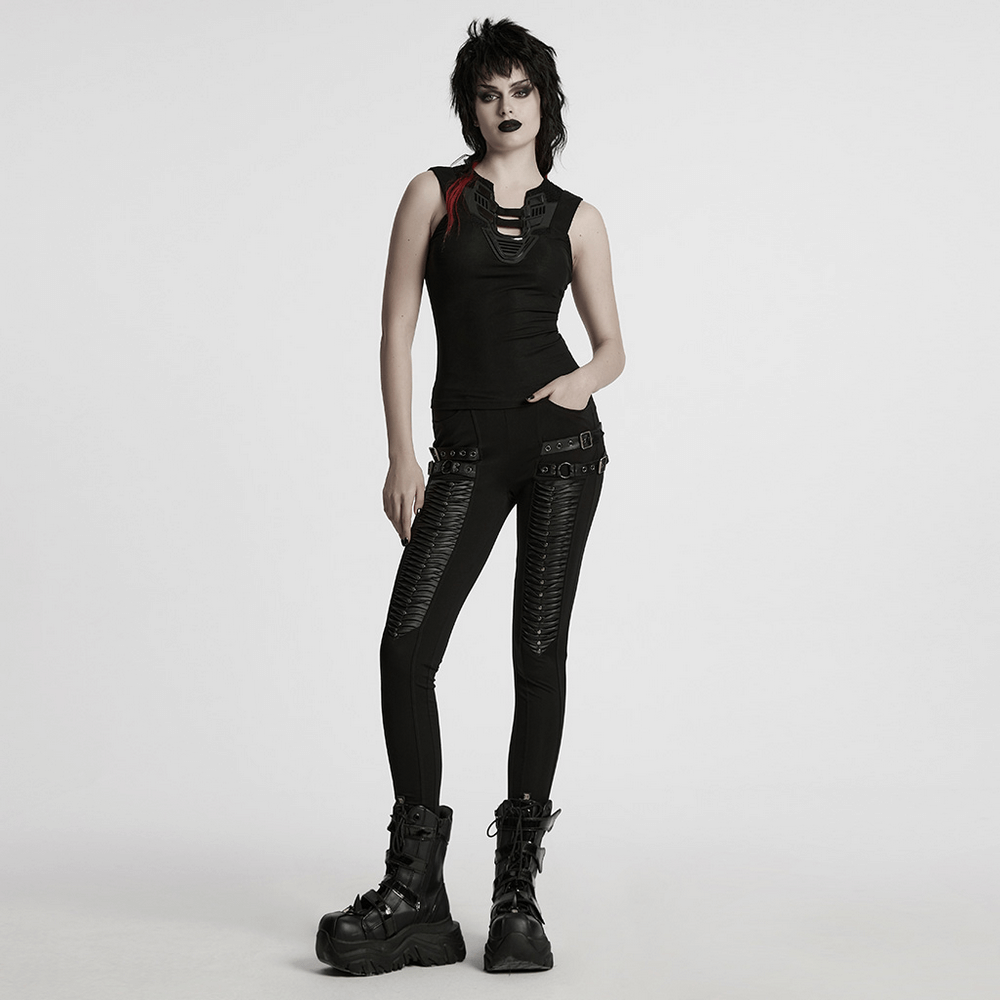 Futuristic black tank top with mesh back, styled with edgy black pants and bold boots for a striking look.