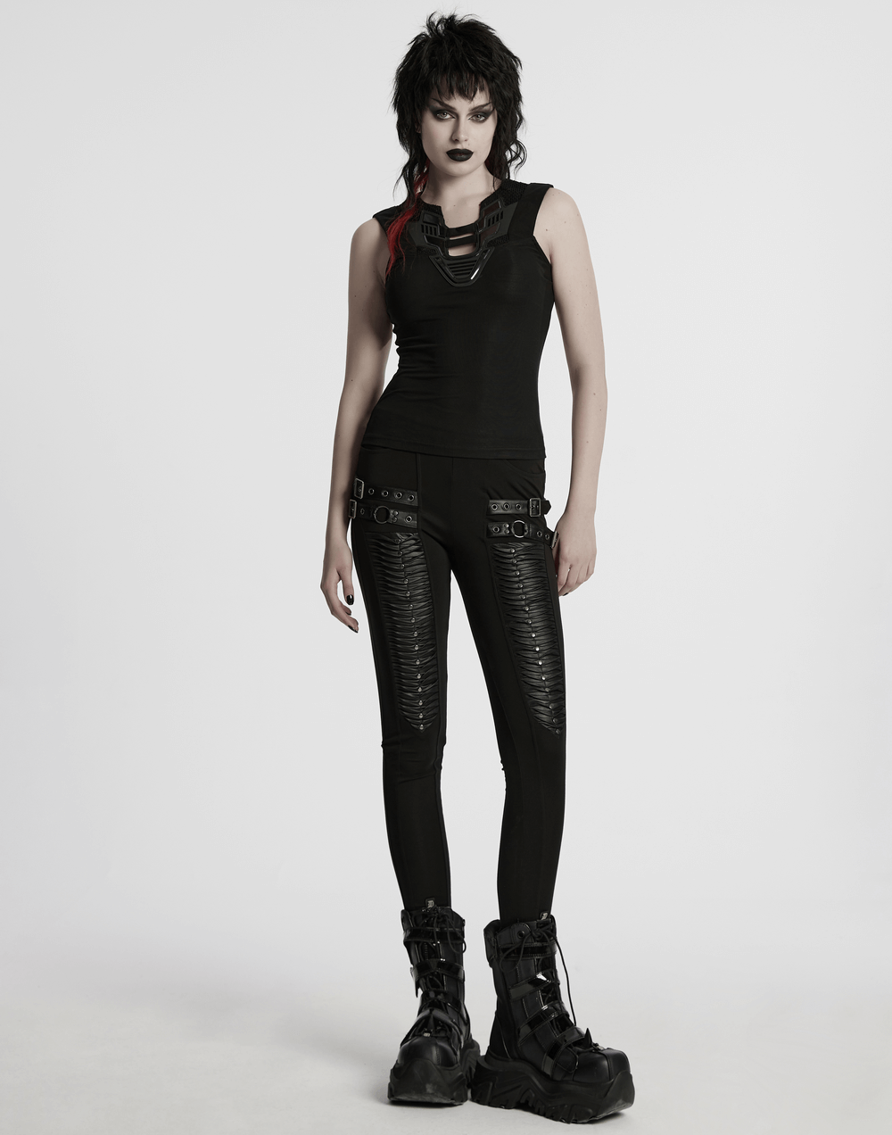 Stylish futuristic black tank top with mesh back, paired with trendy black leggings and bold boots.
