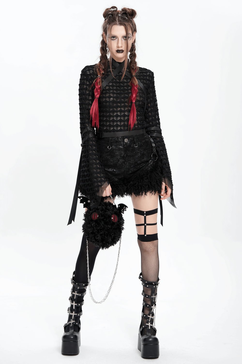 Model in stylish gothic black faux leather shorts with fur trim, paired with edgy accessories and dramatic makeup.