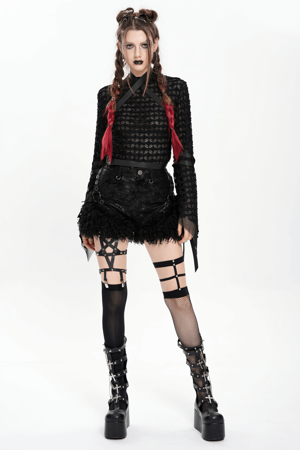 Gothic fashion model in stylish black faux leather shorts with fur trim and edgy strappy accents.