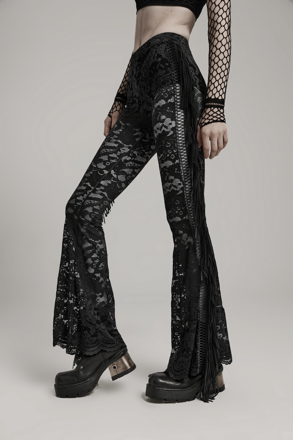 Stylish gothic black lace flared pants with fringe details, perfect for a dramatic night out.