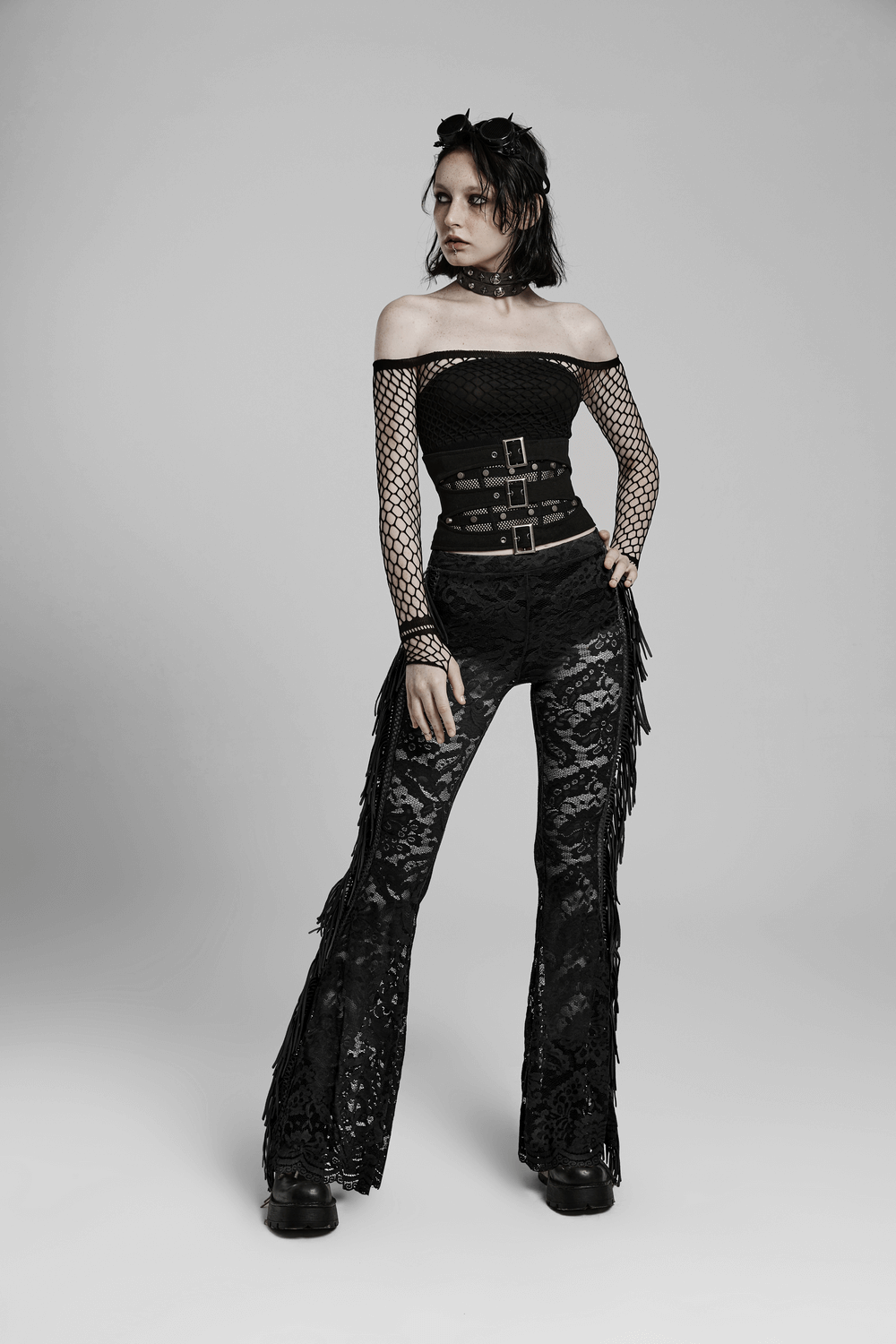 Gothic black lace fringed flare pants styled with a black off-shoulder top and bold accessories for a chic goth look.