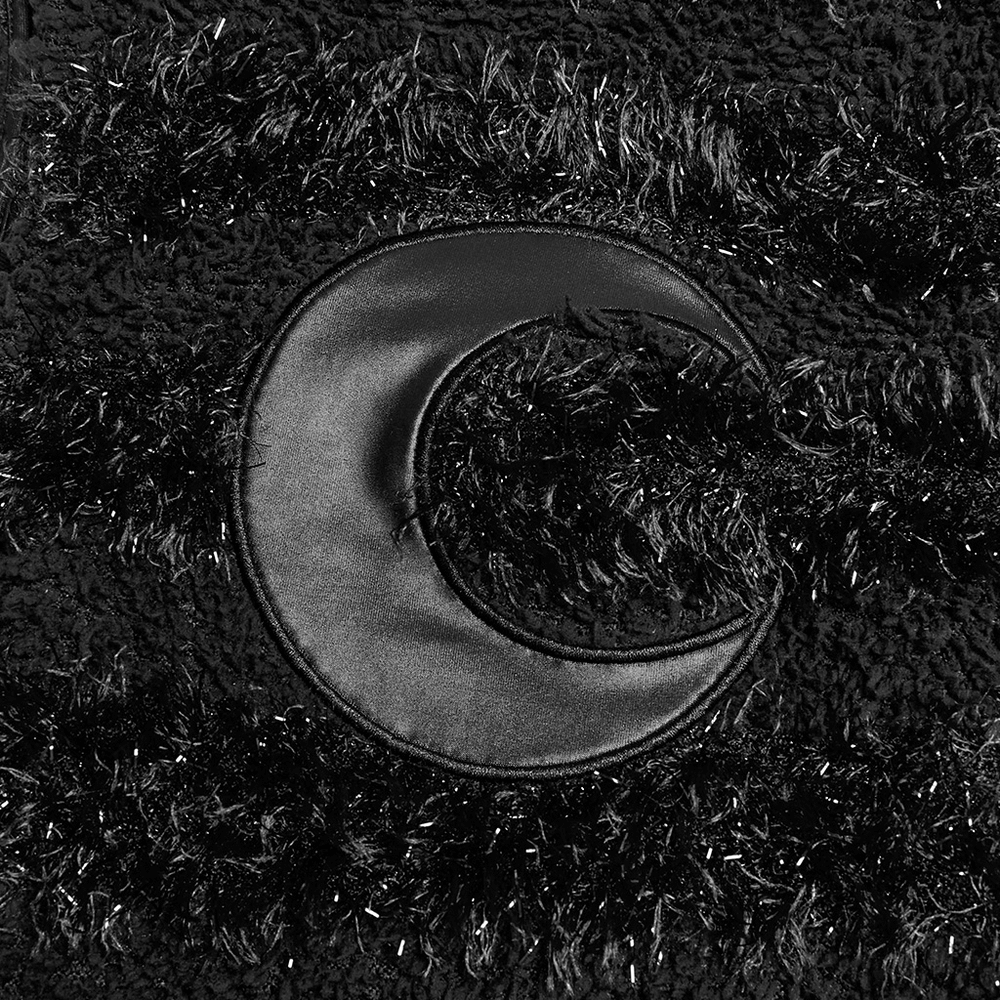 Close-up of the crescent moon embroidery on a stylish gothic black mini dress, featuring vibrant plush and textured fabric.