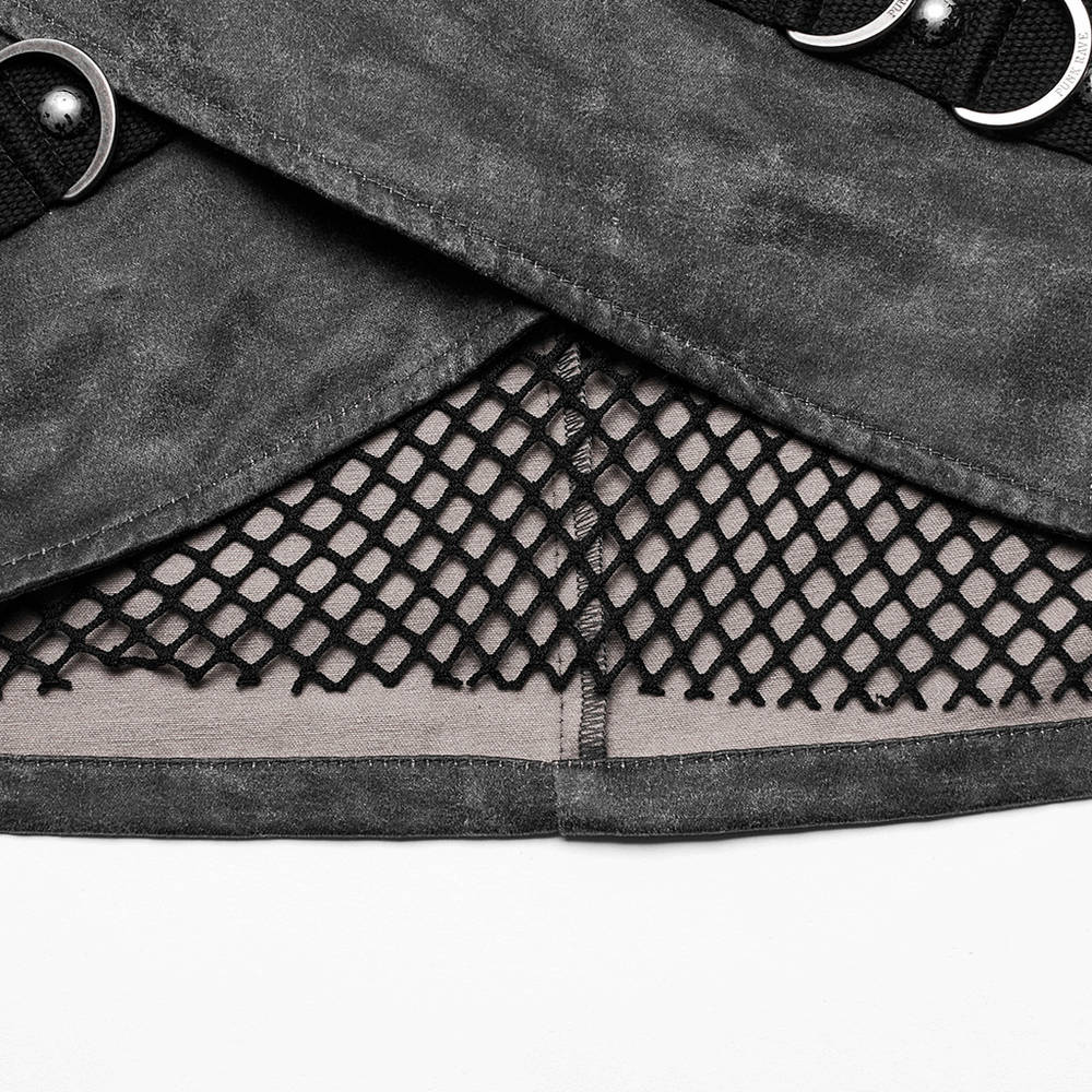 Close-up of stylish gothic mini skirt featuring black mesh and studded accents, showcasing its edgy design and unique texture.