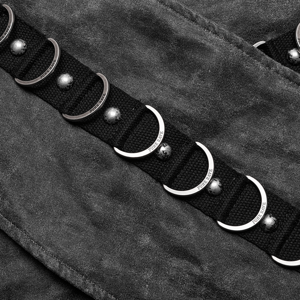 Close-up of edgy D-ring buckle design with studs on a stylish punk skirt.