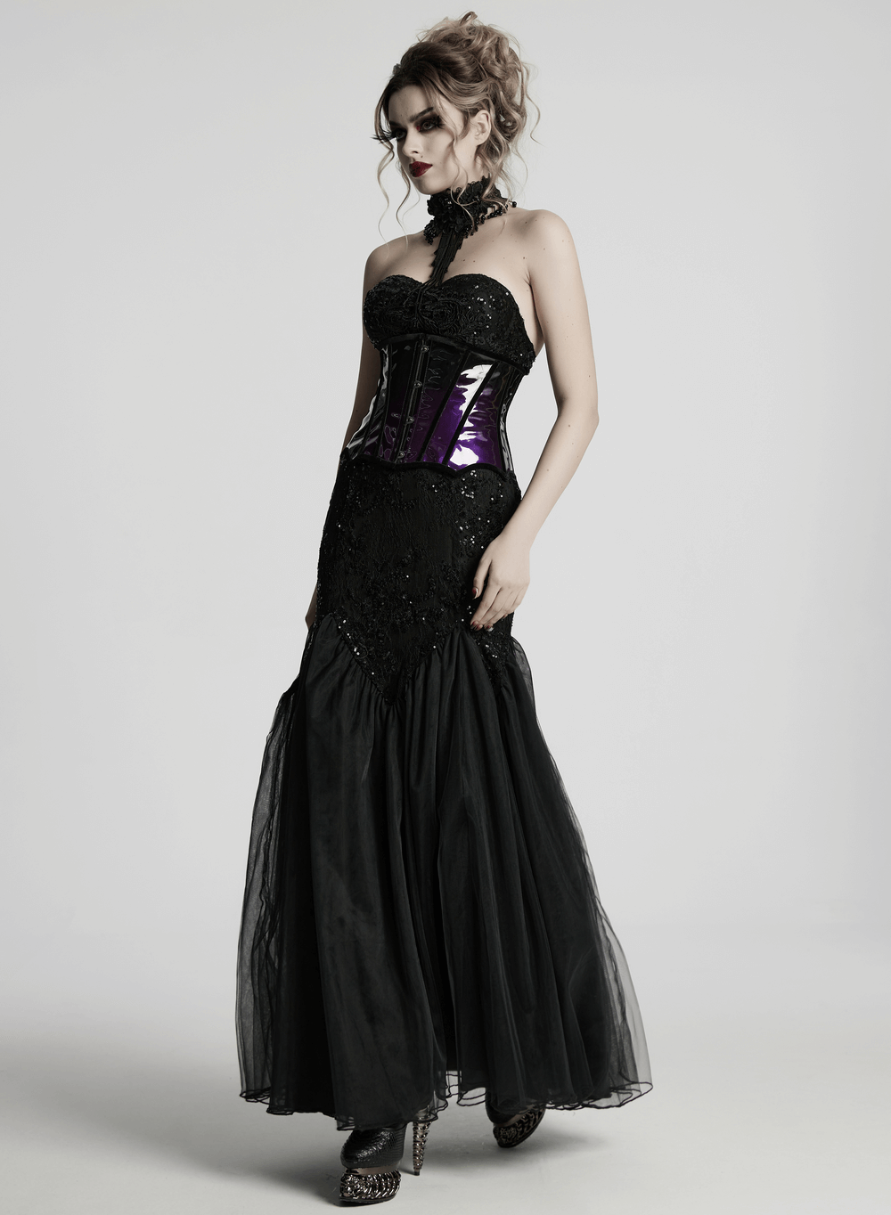 Gothic model showcasing a stylish glossy gradient underbust corset with flowing black gown.