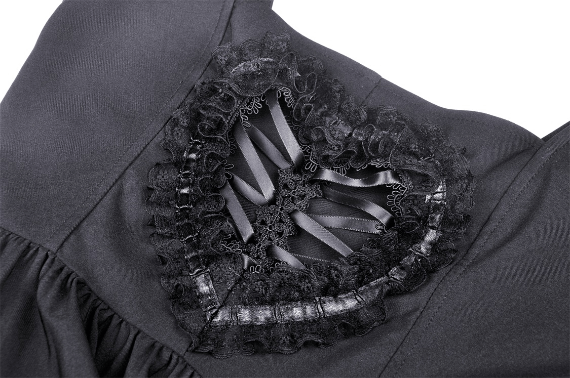 Close-up of heart-cut lace detailing on a black Gothic mini dress featuring delicate ruffles and satin ribbons.
