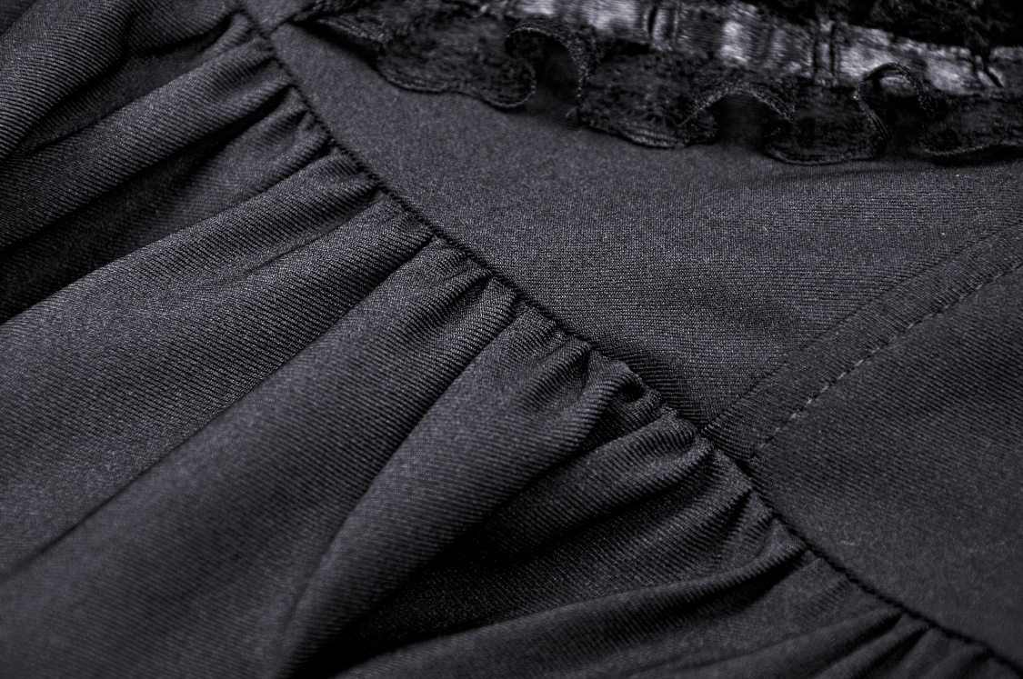Close-up of black lace and ruched fabric detailing on a stylish Gothic mini dress for women.