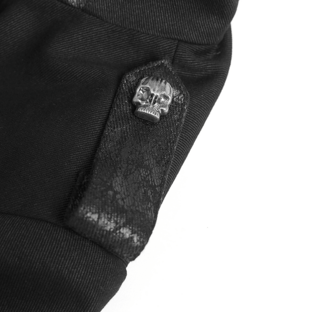 Close-up of stylish gothic trench coat sleeve featuring a silver skull button and lace detail.