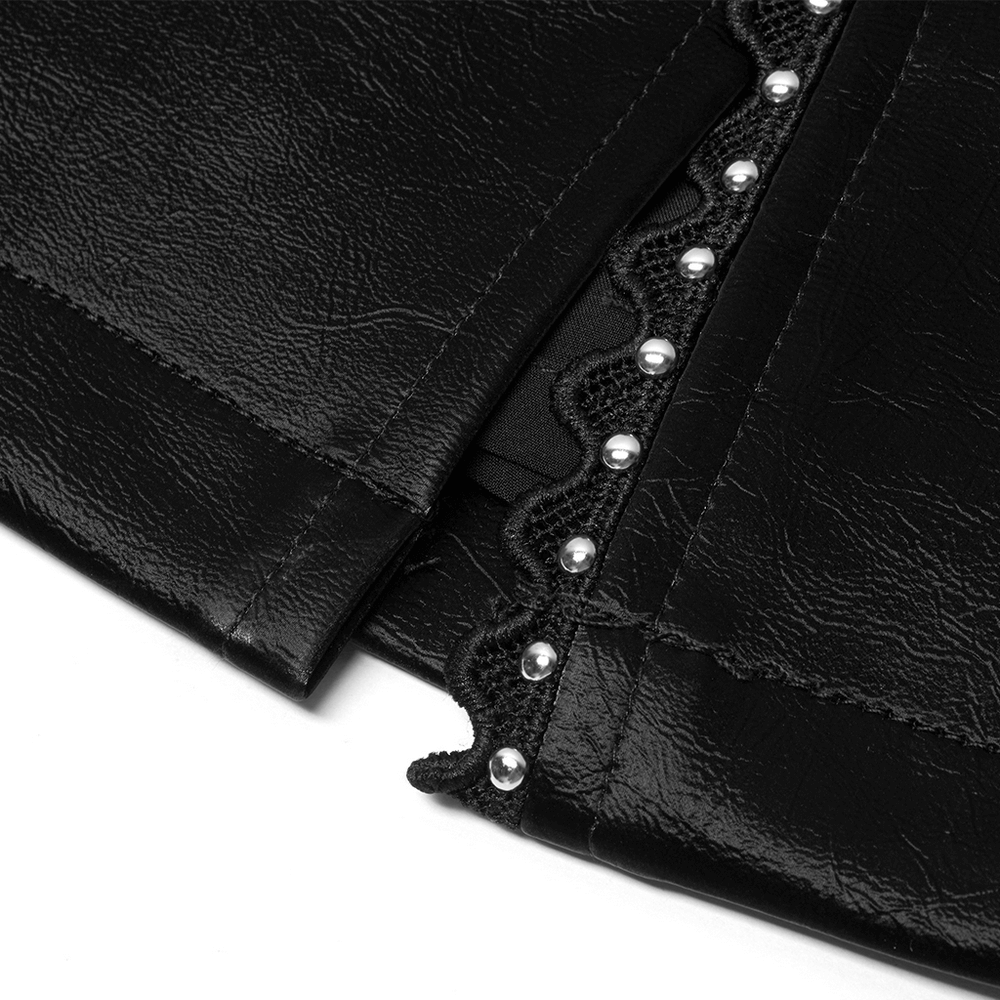 Close-up of Gothic mini skirt detailing with lace and rivet accents on black leather.