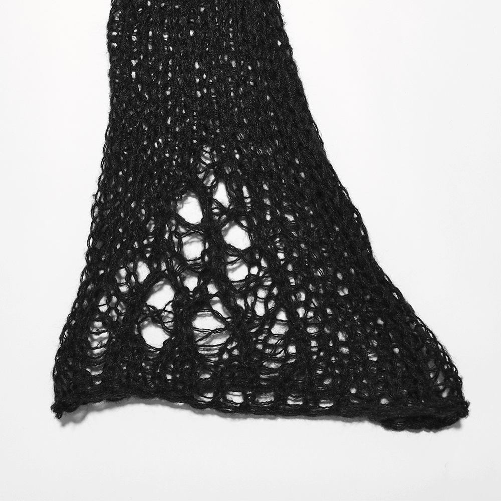 Close-up of stylish black mohair knit leg warmer with unique open weave and flared design for a gothic winter look.