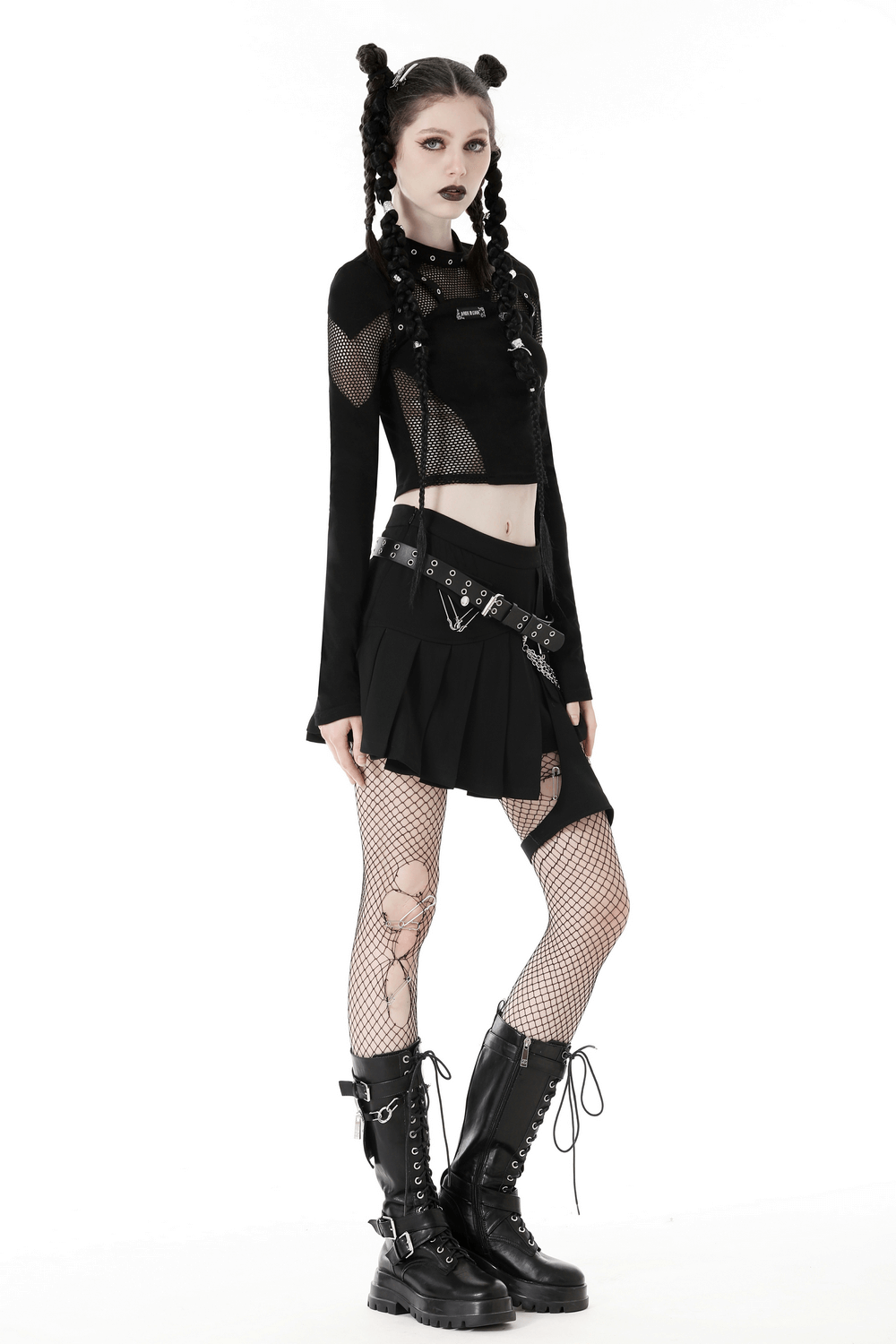 Stylish gothic black mesh crop top with cutouts and long sleeves, paired with a black skirt and fishnet tights.