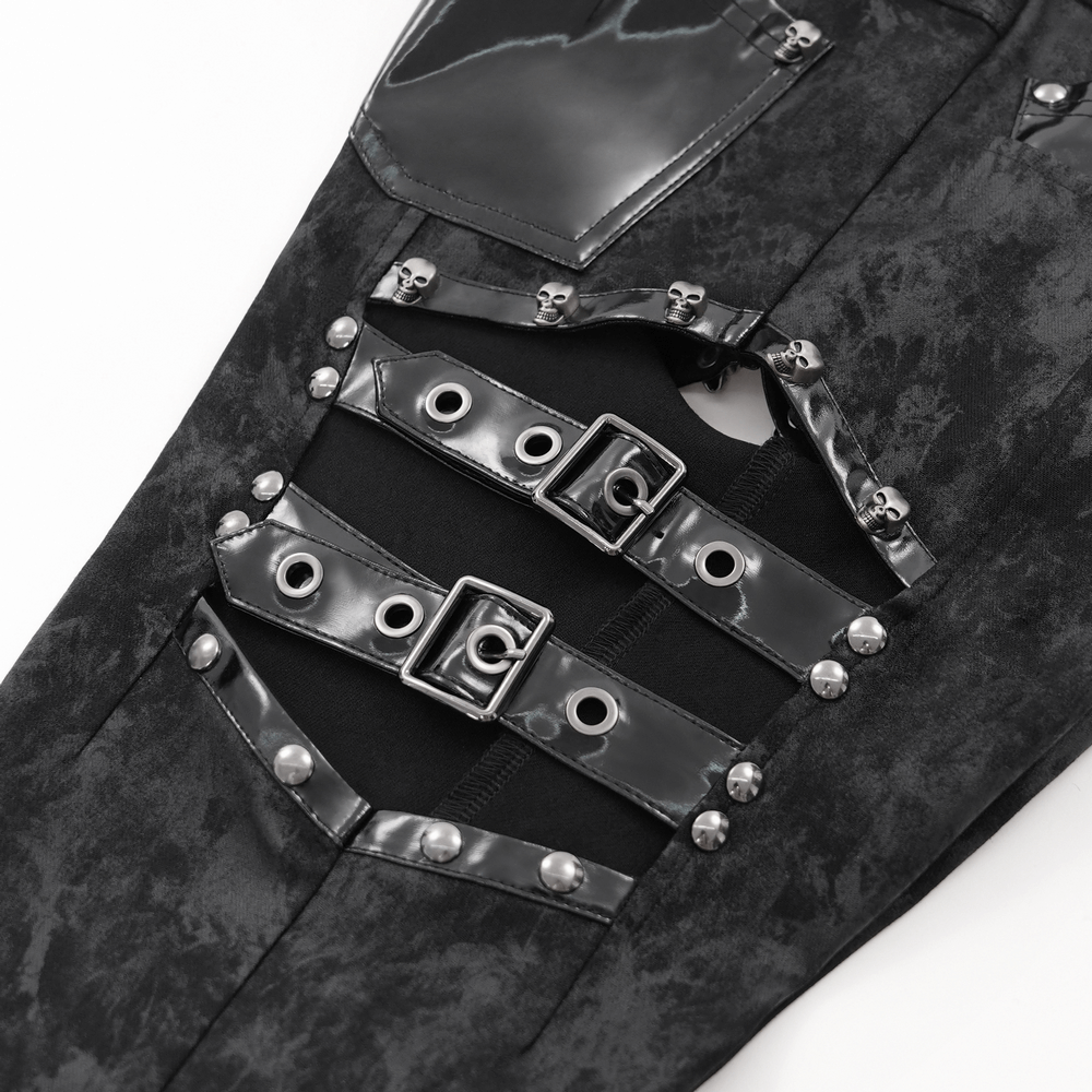 Close-up of stylish gothic pants featuring black side buckles and shiny patent leather pockets.