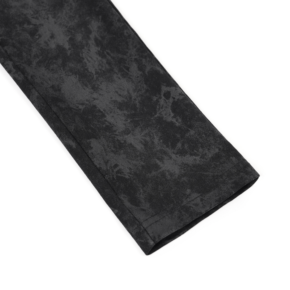 Close-up of stylish gothic pants featuring a textured black fabric with a sleek finish and clean lines.