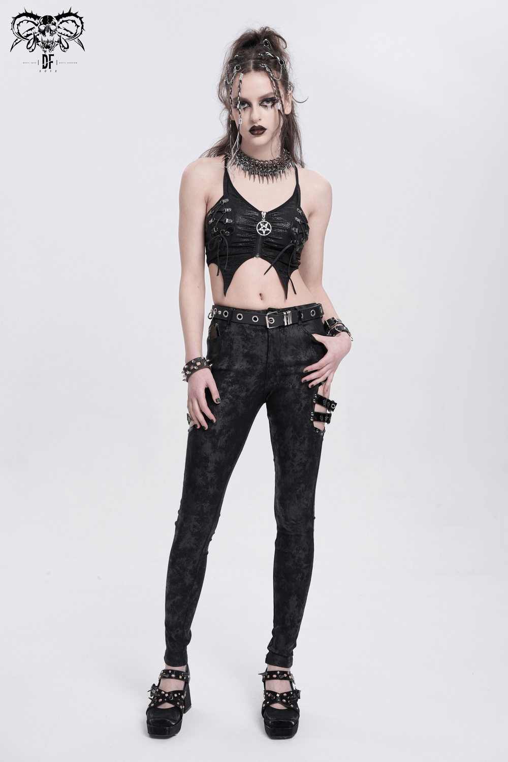 Trendy gothic pants with side buckles, styled with a matching edgy crop top and accessories for a striking look.