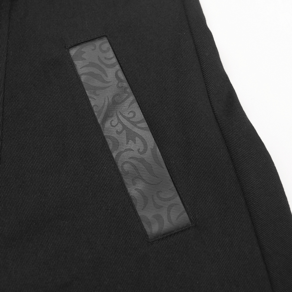 Close-up of a stylish black fabric with textured synthetic leather panel, perfect for modern gothic fashion.