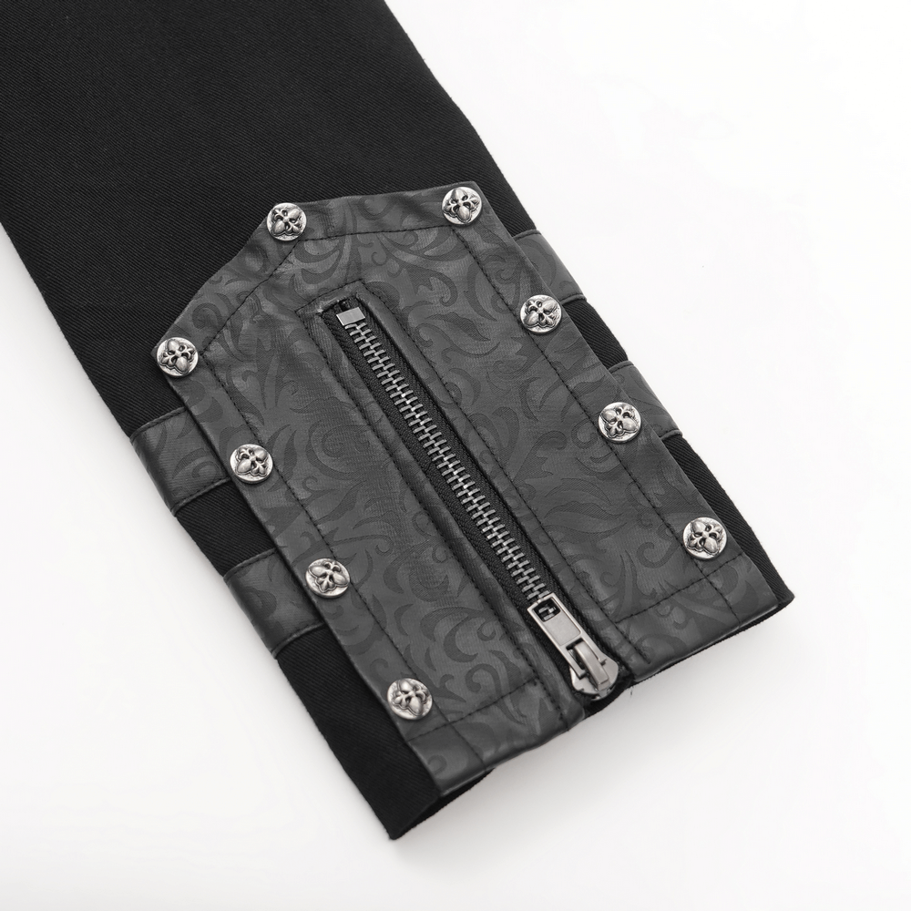 Close-up of gothic trench coat sleeve featuring synthetic leather panel and decorative metal studs.