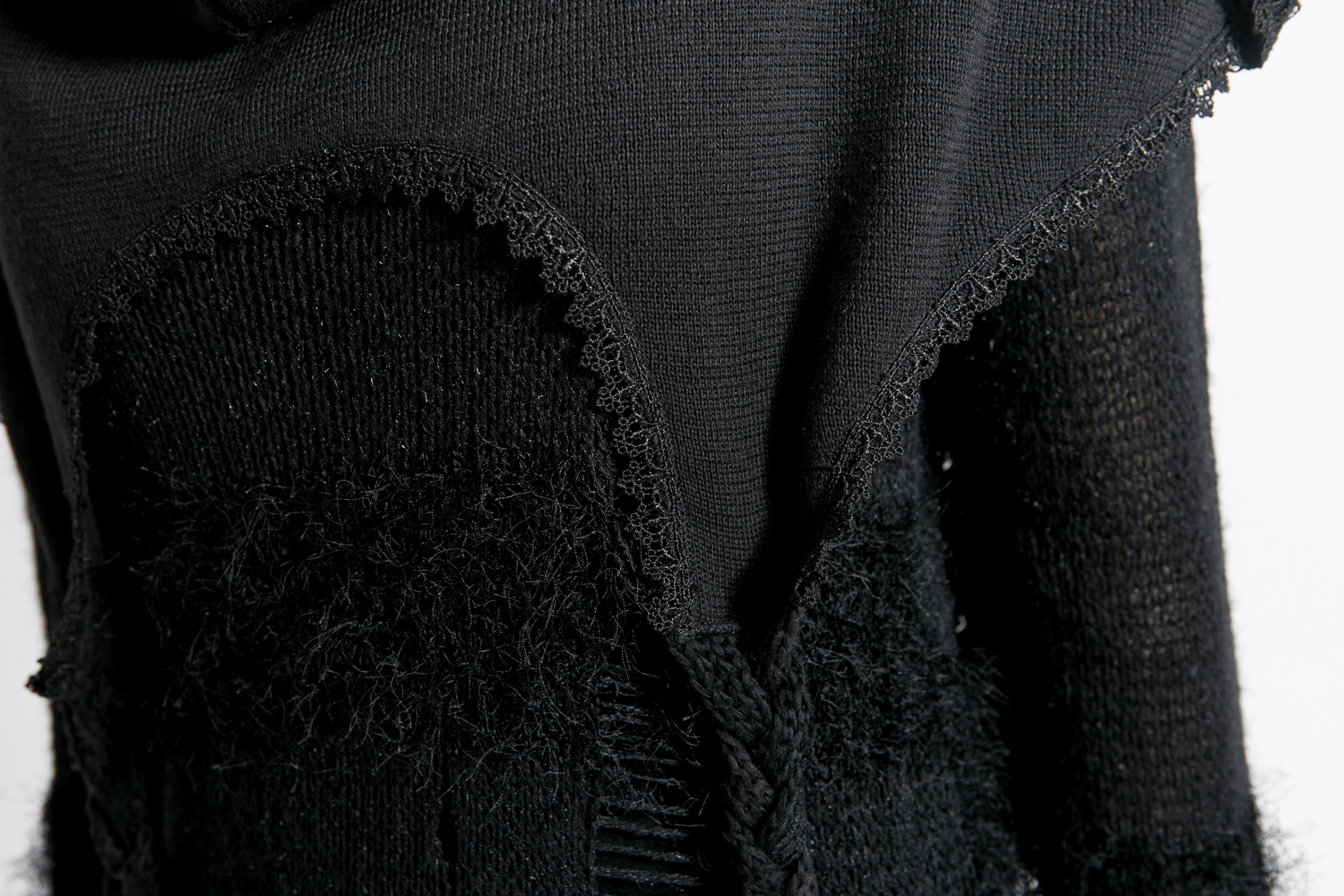 Close-up of stylish gothic black wool hooded wrap cape showcasing textured fabric and unique design details.