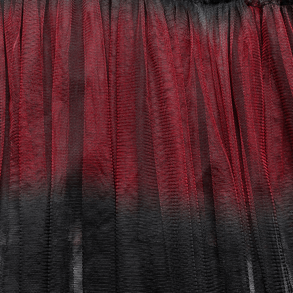 Close-up of stylish gradient mesh fabric in red and black, showcasing layers of an asymmetrical half skirt.