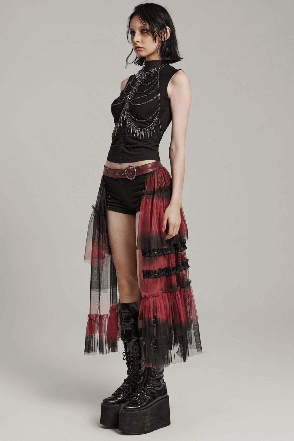 Stylish gradient mesh half skirt paired with punk belt, showcasing edgy asymmetrical design and layered aesthetic.