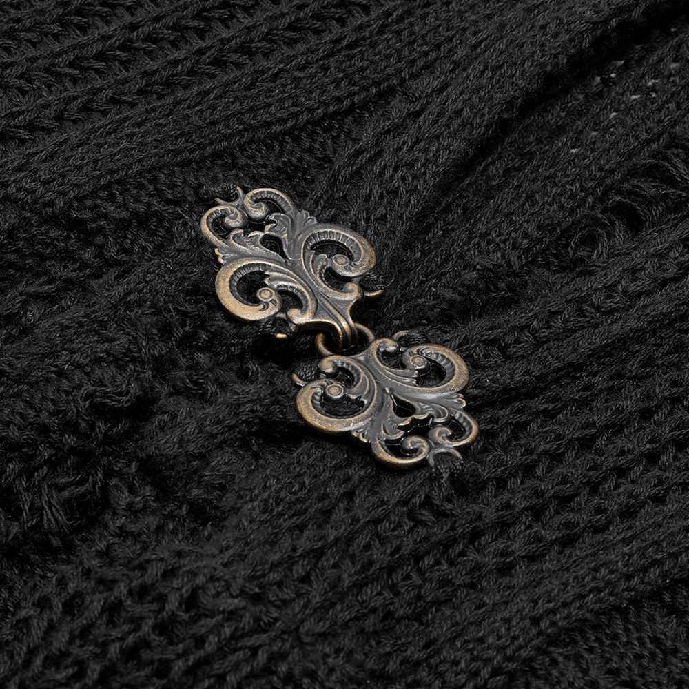 Close-up of elegant vintage clasp on a stylish black gothic cardigan, showcasing intricate detail and texture.