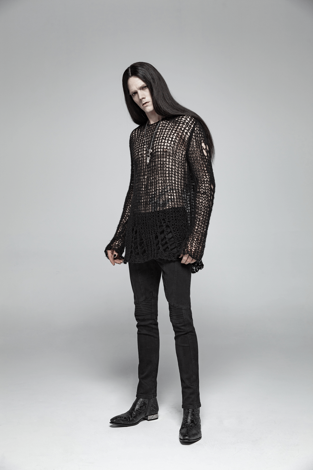 Chic model wearing a stylish knit mesh pullover sweater, showcasing a trendy and breathable design for a standout look.