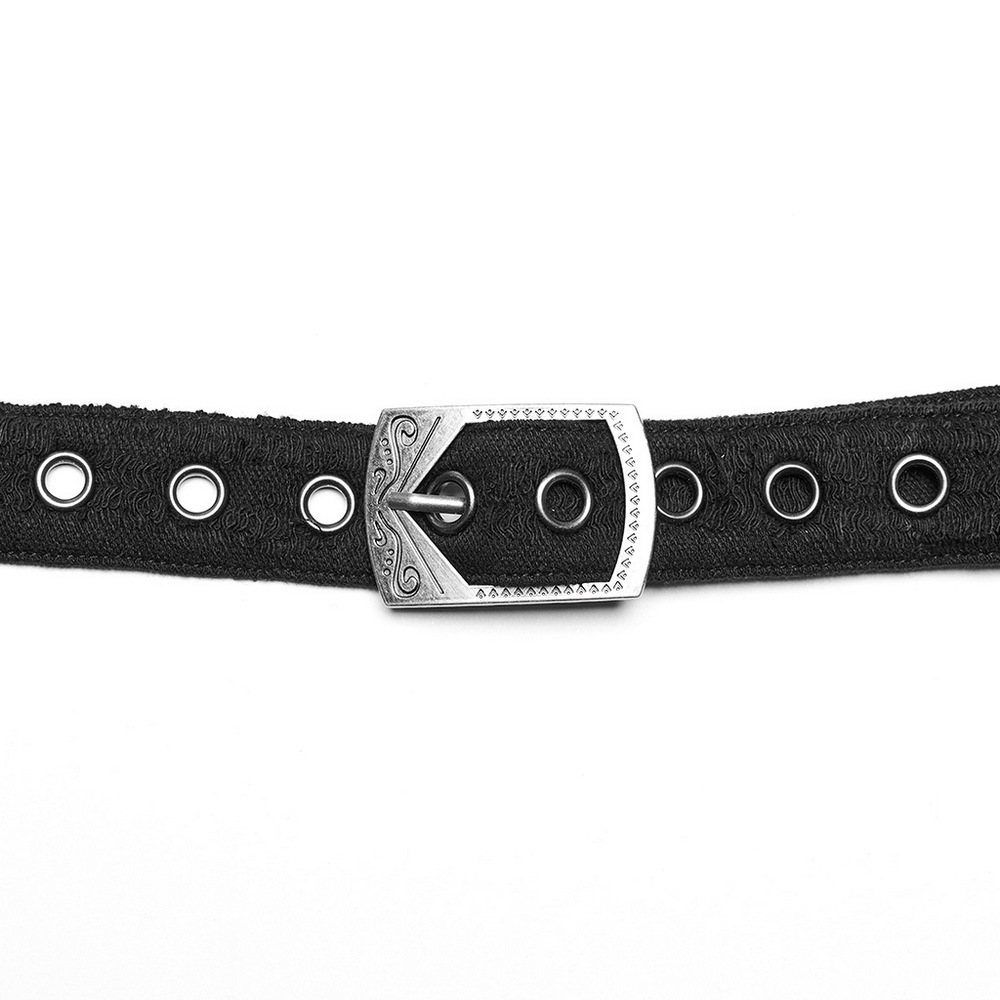 Close-up of a black belt with a stylish silver buckle and metal eyelets for adjustable fit.