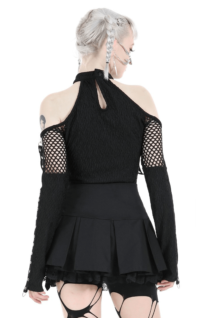 Back view of a stylish black lace top with cutouts and lace-up sleeves, paired with a flared black skirt.