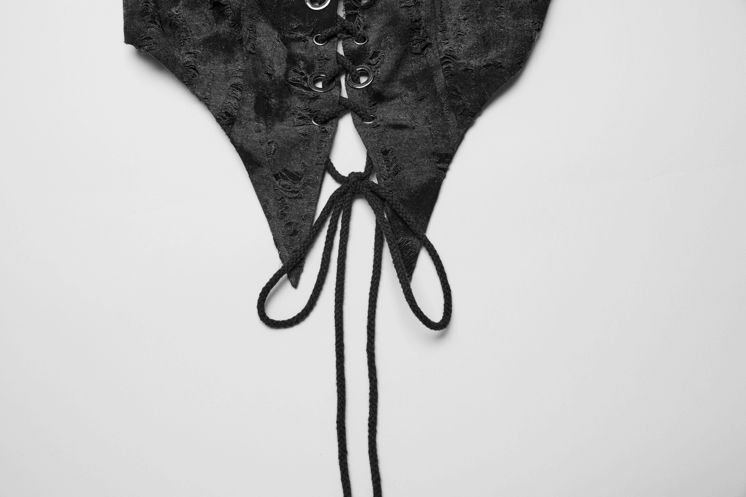 Stylish back of a lace-up black halter crop top with pointed hem and adjustable drawstrings.