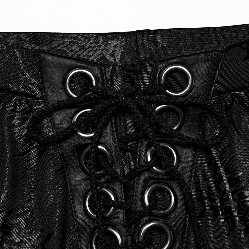 Close-up of stylish black lace-up detail on flared pants, showcasing sparkling tree texture and edgy design.