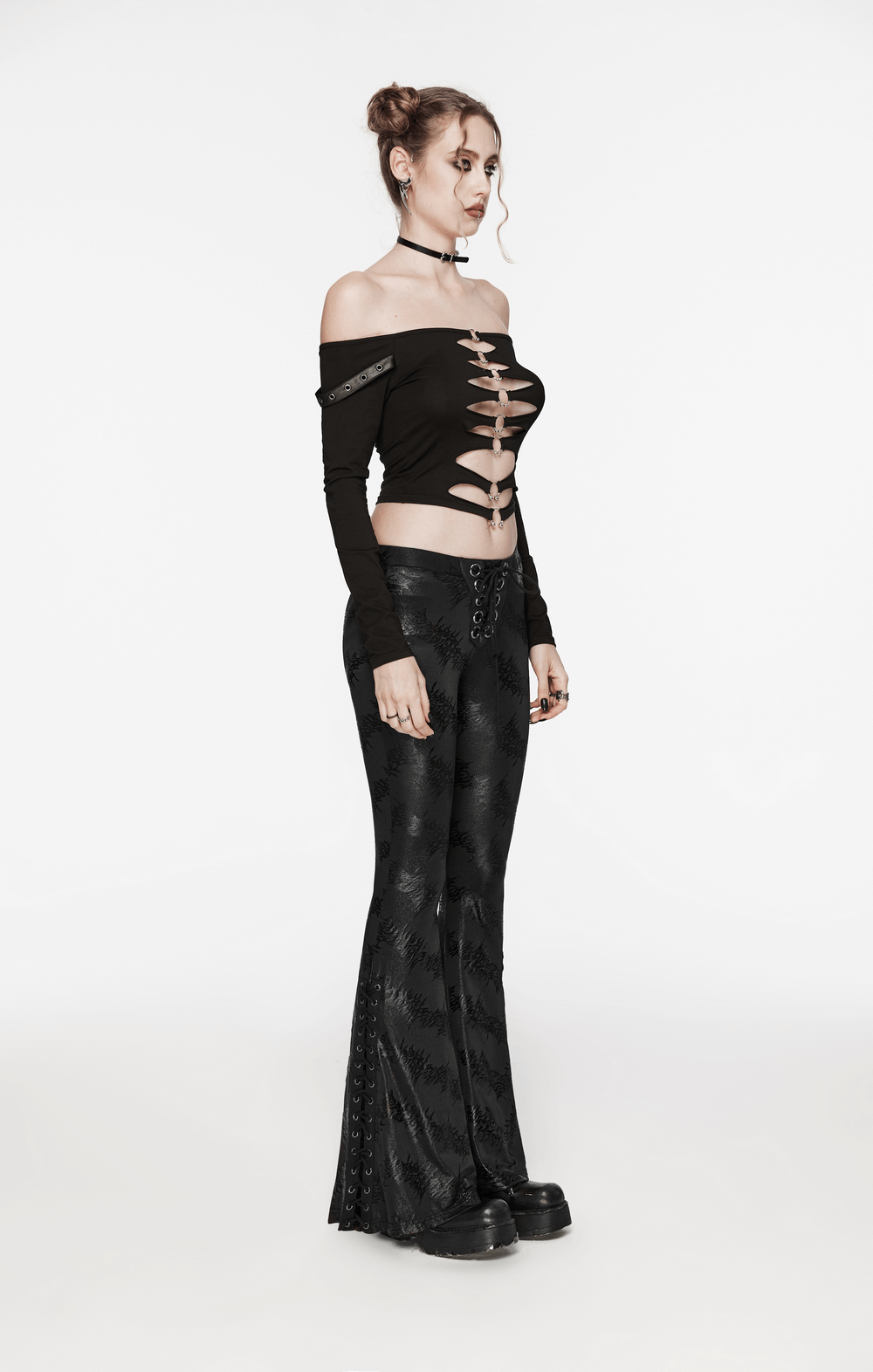 Stylish women’s black lace-up flared pants with sparkling tree texture, paired with an edgy off-shoulder top.