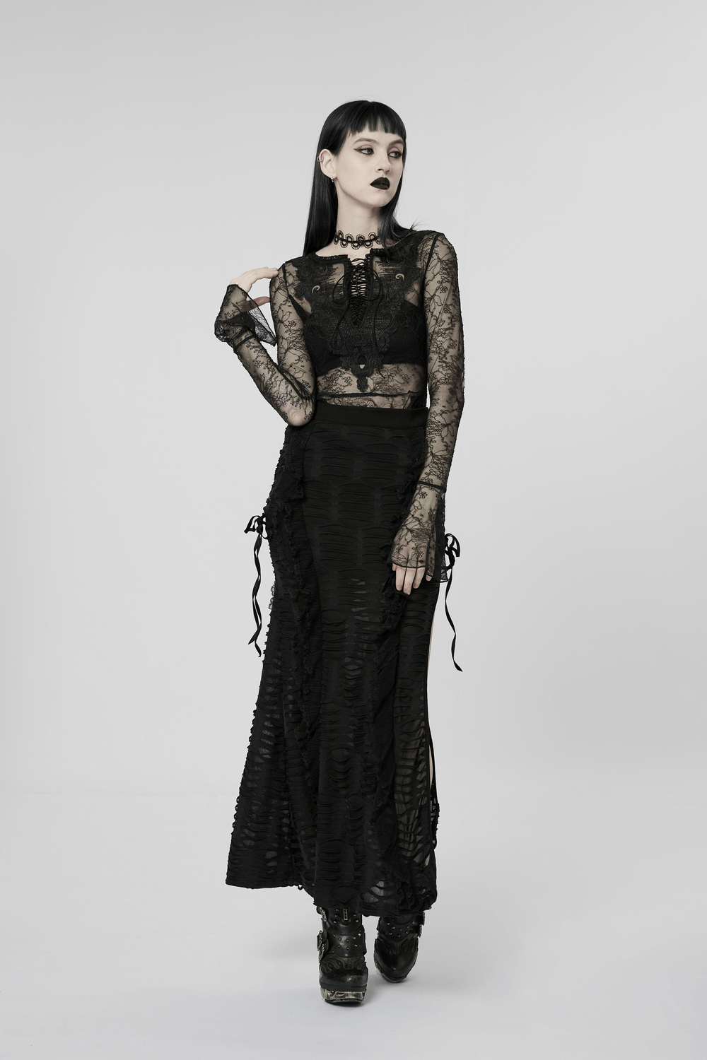 Model showcasing a stylish layered gothic ruffle skirt with a high slit, paired with a lace top and accessories.