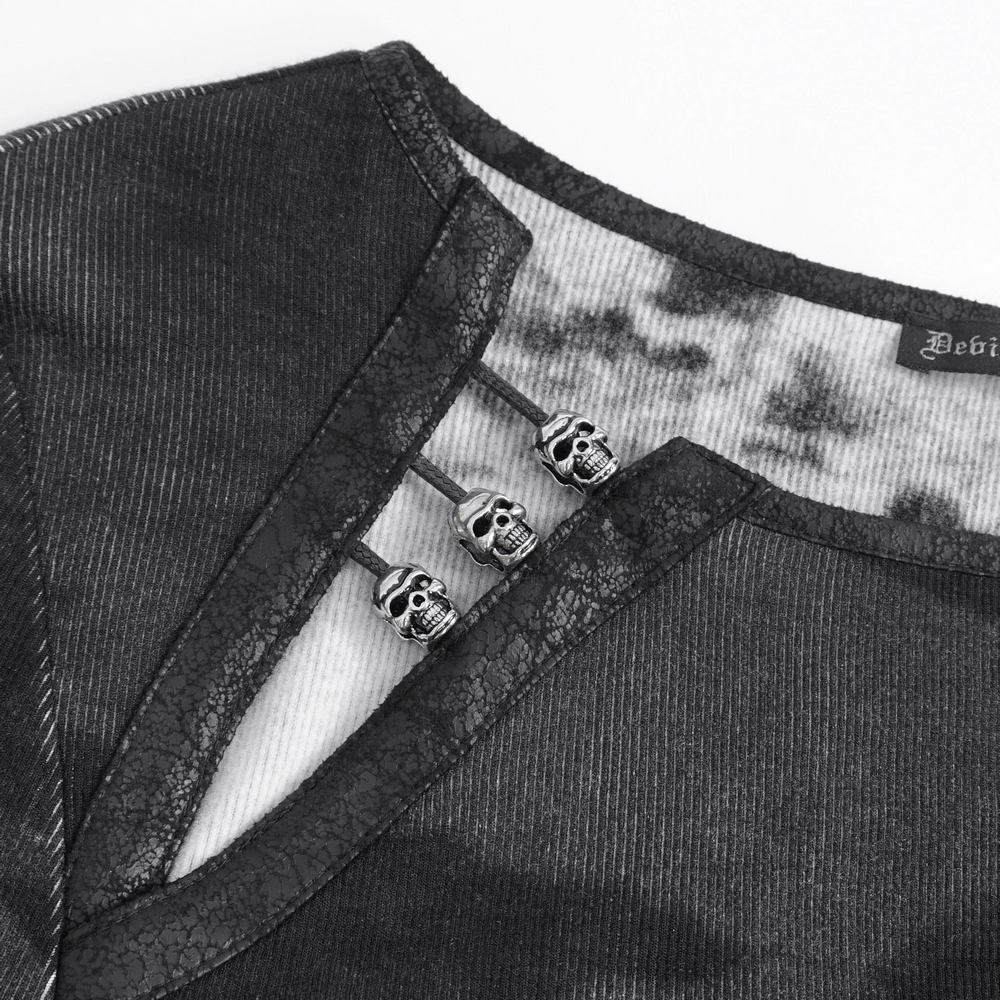 Close-up of stylish long sleeves asymmetric top featuring skull buckle detail on the shoulder.