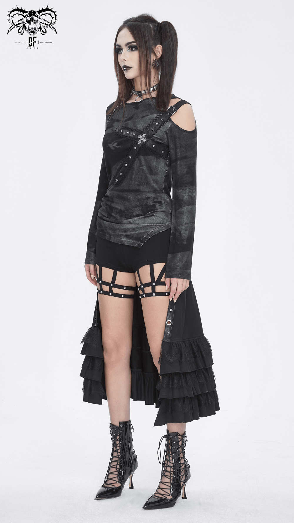 Punk women’s edgy long sleeve asymmetric top with buckle detail, paired with stylish ruffled layers and chic lace-up boots.