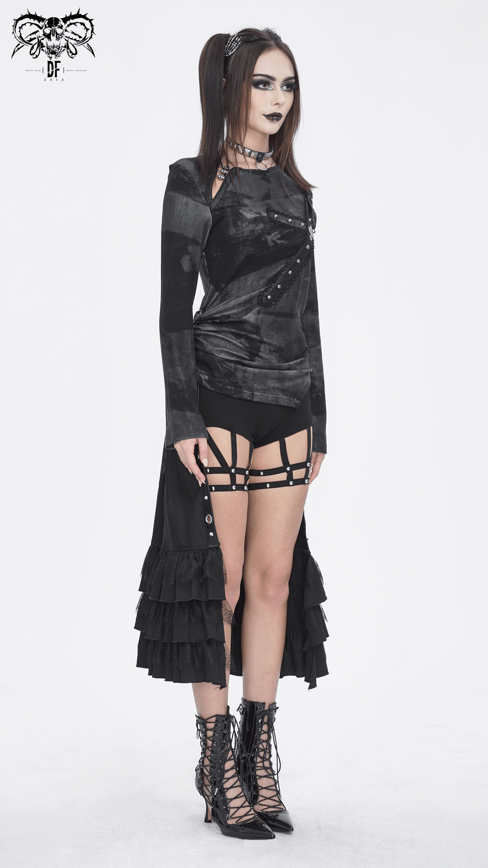 Punk women's long-sleeve asymmetric top with buckle detail, paired with edgy accessories and stylish boots.