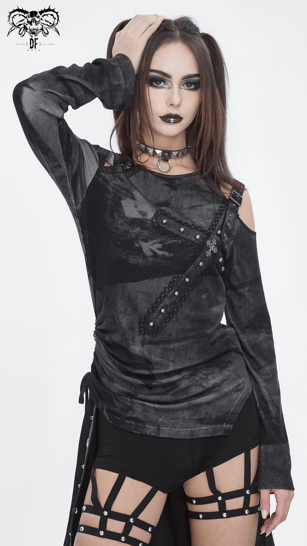 Punk style long sleeves top with shoulder buckle detail, paired with edgy accessories for a bold fashion statement.