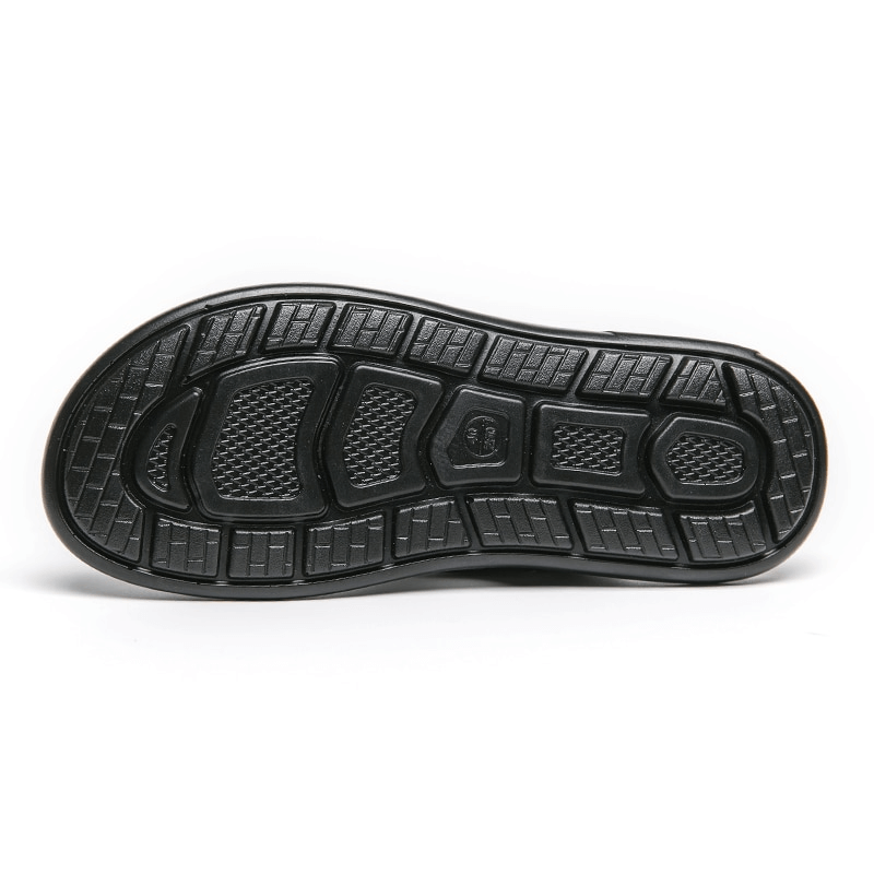 Sleek black outsole of stylish male PU leather slippers designed for comfort and durability.