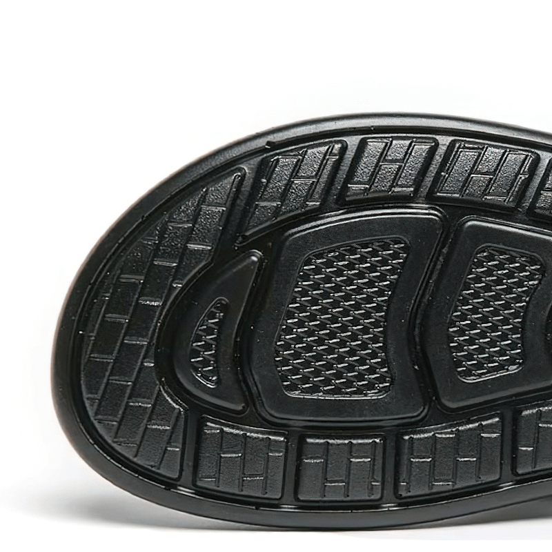 Sole of stylish male PU leather slippers showing textured pattern for superior grip and comfort.