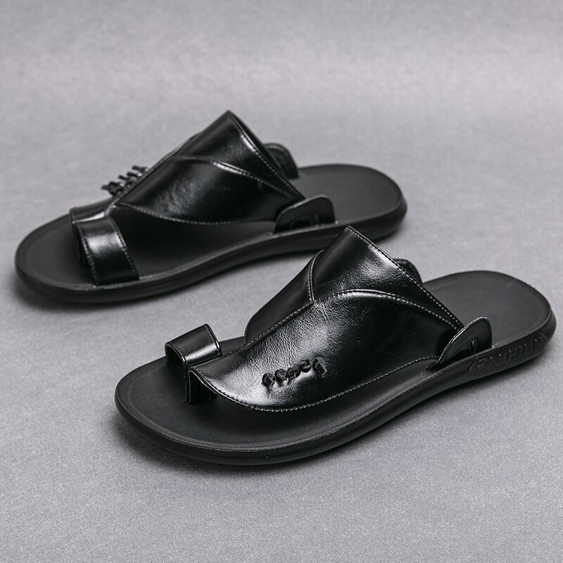 Stylish male PU leather slippers in sleek black, perfect for casual elegance and comfort.